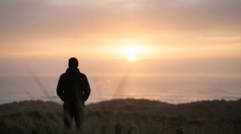 Silhouette of a person looking toward a sunrise, symbolizing hope after divorce.